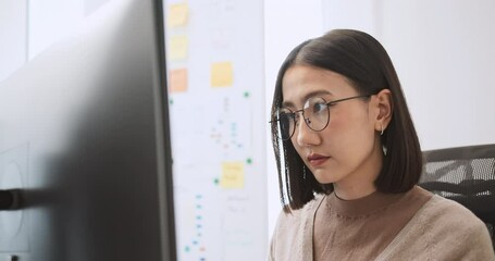 Young adult Asian male, female software developer coding program on desktop computer. Woman work from home, remote working, freelance programmer job, smart digital nomad lifestyle concept