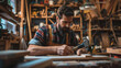 © DesignStorez - Focused Carpenter Working in a Woodshop with Hand Tools