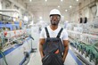 © Serhii - Portrait of industrial engineer. Smiling factory worker with hard hat standing in factory production line