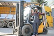 © Serhii - African American Man at work. Professional operation engineering. Young worker forklift driver