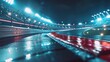 © Karolis - A wet racetrack curves under bright stadium lights, reflecting off the slick surface. Empty grandstands and safety barriers line the brightly illuminated scene.