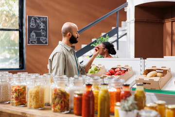 Canvas Print - Arab man at local supermarket admiring locally grown organic and nutritious produce. Middle eastern client doing sustainable shopping to support local vendors and zero waste lifestyle.