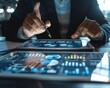 © Daria - Professionals analyzing financial data on tablet for project and sales strategy in office setting
