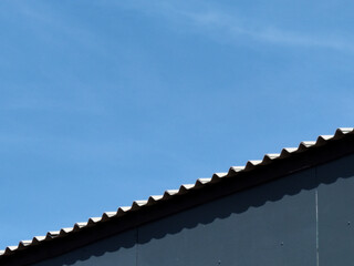 Canvas Print - metal roof tiles with blue sky background