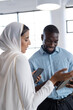 © Wavebreak Media - Discussing work, business colleagues using smartphones and tablet in office setting