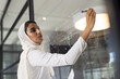 © Wavebreak Media - Writing on glass board, businesswoman brainstorming ideas in modern office