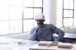 © Wavebreak Media - Using VR headset, man sitting at desk in modern office environment