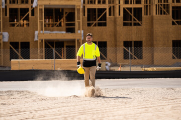 A construction worker in highvisibility gear emphasizes safety and professionalism at a dusty work site