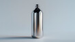 © Kashif - A classic stainless steel bottle, its surface polished and reflective, standing alone on a plain white background.