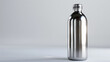 © Kashif - A classic stainless steel bottle, its surface polished and reflective, standing alone on a plain white background.