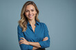 © Introvertia - Portrait of smiling young woman confidently with long blonde hair in blue shirt