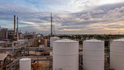 Poster - Aerial view oil and gas refinery at night, Business petrochemical industry refinery oil and gas factory power and fuel energy, Oil and gas storage tank fuel refinery industry at night.