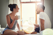© Hira/peopleimages.com - Home, bedroom and couple with breakfast, marriage and conversation with happiness, anniversary and romance. Apartment, man and woman with tea, nutrition and healthy meal with time together or morning