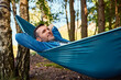 © baranq - Carefree adult man relaxing in hammock