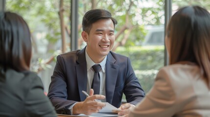 Wall Mural - An Asian financial advisor meeting with clients to discuss investment options. 