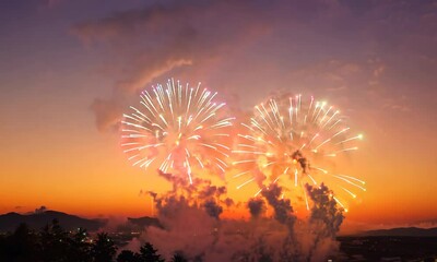 Sticker - Vibrant fireworks in the sky, the sky is orange and the clouds are white. The clouds are low and the sun is setting