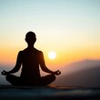 © Tonton54 - Silhouette of a person meditating at sunrise with mountains in the background, capturing a moment of peace and tranquility.