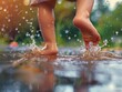 © Johannes - Closeup of feet of little child playing in rain outdoors with water splash