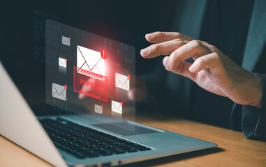 business man using smartphone and computer that show warning sign after got attack phishing email by