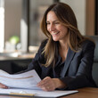 © Talal - portrait of a business woman,Smiling female financial advisor, attorney lawyer or bank manager consulting client investor reading document at business meeting reviewing legal paper file planning taxes