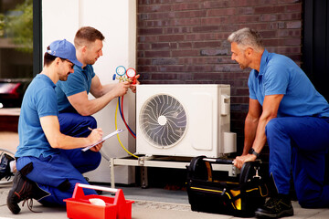 Experienced Technician Inspecting Air Conditioning Units