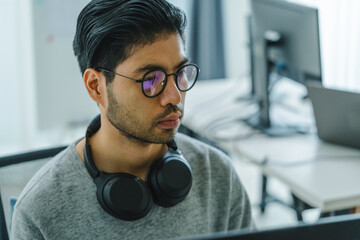 Wall Mural - asian man prompt engineer develop coding app with software data sitting in front of computer monitor