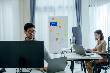 Wall Mural - asian woman  and Indian man Developer team working  about programming software data online at office