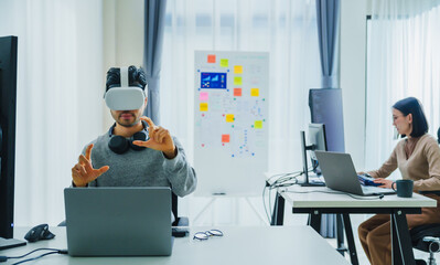 Wall Mural - asian and indian developer program coding sent to virtual reality headset to implement ai project at