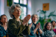 © ty - Group of mature women applauding while visiting business training class in the office