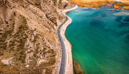 Wall Mural - Aerial view of a winding driveway separating  mountains and lakes in Kuche Dalongchi in Xinjiang, China