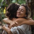 © Da - Happy Female Holistic Coach Embracing Young Woman in Spiritual Practice, Feeling Gratitude and Love, Providing Emotional Support During Wellness Retreat, Confidence, Female Empowerment, Stress Relief,