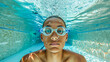 © João Macedo - Young swimmer boy posing underwater wearing goggles in a swimming pool