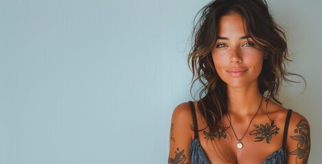 Wall Mural -  A portrait of an attractive young  woman with , tattooed arms and neck in front of a great  background, wearing bohemian style , smiling at the camera with studio lighting, copy space for text