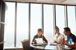 © ReeseArcurs/peopleimages.com - Paper, financial advisor or couple at table in meeting for insurance, policy update or budget in office. Broker, negotiation or consulting with people for investment, future plan or contract review