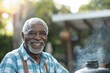 © ChaoticMind - An older man with gray hair and beard, wearing a blue checkered shirt, barbecues in a sunny backyard. His smile reflects contentment and the joy of outdoor cooking.