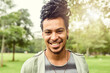 © peopleimages.com - Man, portrait and park with young person happy about nature, travel and freedom. Freelance musician, smile and student busker in New York, countryside and garden relaxing for summer fun and health