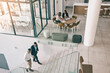 © peopleimages.com - Business people, stairs and high angle of office for corporate work, accounting agency and reception area. Male partners, women and success in company on steps, start or morning in finance department