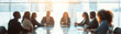© NIPAPORN - Blur background Business meeting with diverse team members around a conference table Office