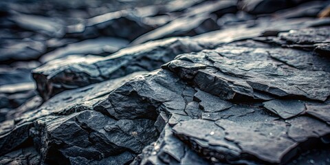 Wall Mural - Close-up of a rugged, dark gray rocky surface with uneven details , texture, close-up, rock, stone, background, surface, rough