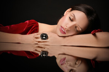 Wall Mural - Beautiful young woman with elegant jewelry on black background