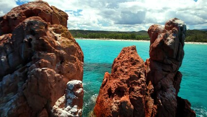 Canvas Print - Italy . Most scenic beaches of Sardinia island (Sardegna) - beautiful Cea with red rocks (Faraglioni). on the south of Capo Bellavista near Tortoli. aerial drone 4k hd video