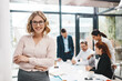 © ReeseArcurs/peopleimages.com - Crossed arms, manager and portrait of business woman in office with confidence for career growth. Smile, pride and female finance banker with team for company investment with meeting in boardroom.