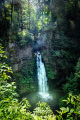 wilczki waterfall surrounded with green forest in miedzygorze, poland.