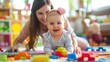 © antkevyv - Motherhood moments mother playing with baby on floor, cheerful blocks colorful bright