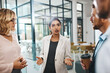 © ReeseArcurs/peopleimages.com - Woman, business people or talking to meeting in modern office for teamwork, ideas or collaboration. Entrepreneur, investor and shareholder speaking in discussion for feedback, planning or project