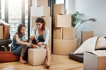 Wall Mural - Mother, girl and help with packing boxes for new home with moving, mortgage investment and property relocation. Woman, daughter and support with tape for cardboard package or real estate in apartment