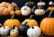 © Lied - Assortment of colorful pumpkins and gourds, including black, orange, and white varieties, arranged in a display