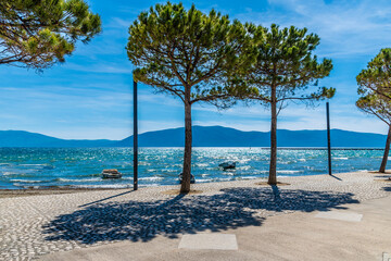 Wall Mural - A view past trees out to sea from the seafront at Vlore in Albania in summertime