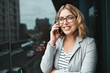 © ReeseArcurs/peopleimages.com - Woman, outside and speaking or phonecall for business, communication and discussion with virtual client. Negotiation, corporate employee and talking for feedback, conversation and city balcony
