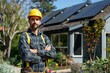 © Oksana - Confident construction worker standing with crossed arms in front of a house with solar panels. Outdoor portrait for construction and renewable energy design.